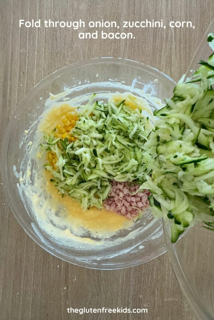 Fold in onion, zucchini, corn, bacon, and cheese.