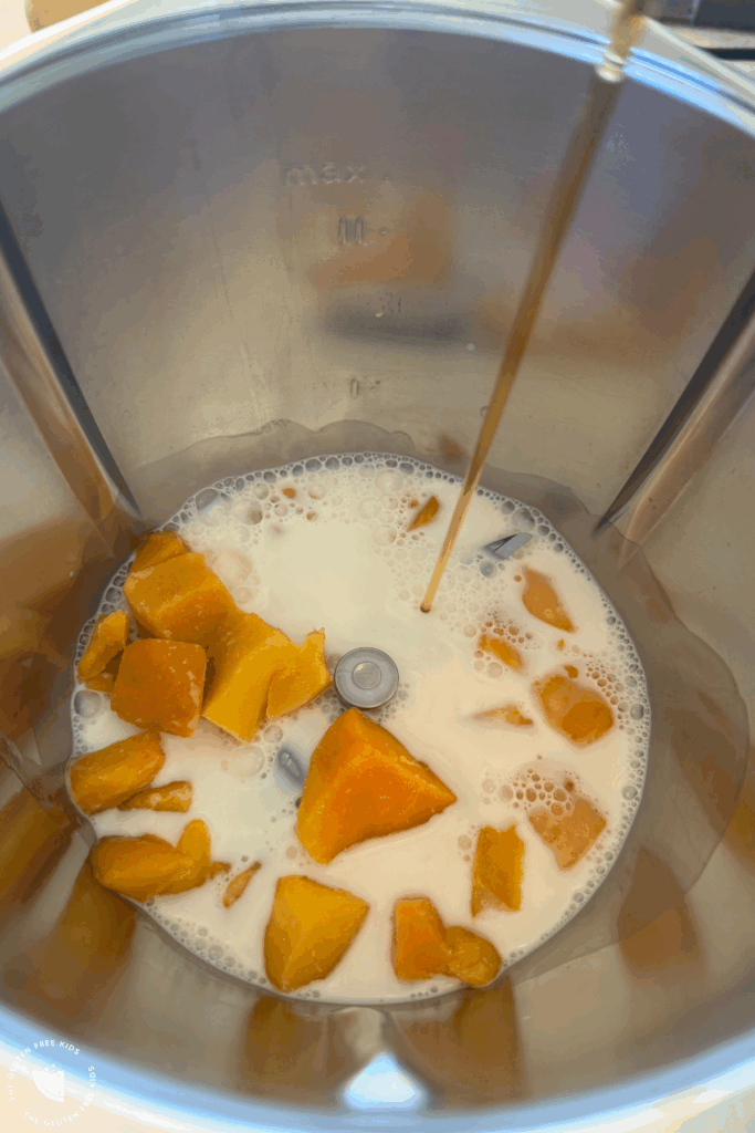 In a blender, combine the milk, mango, and a dash of maple syrup.