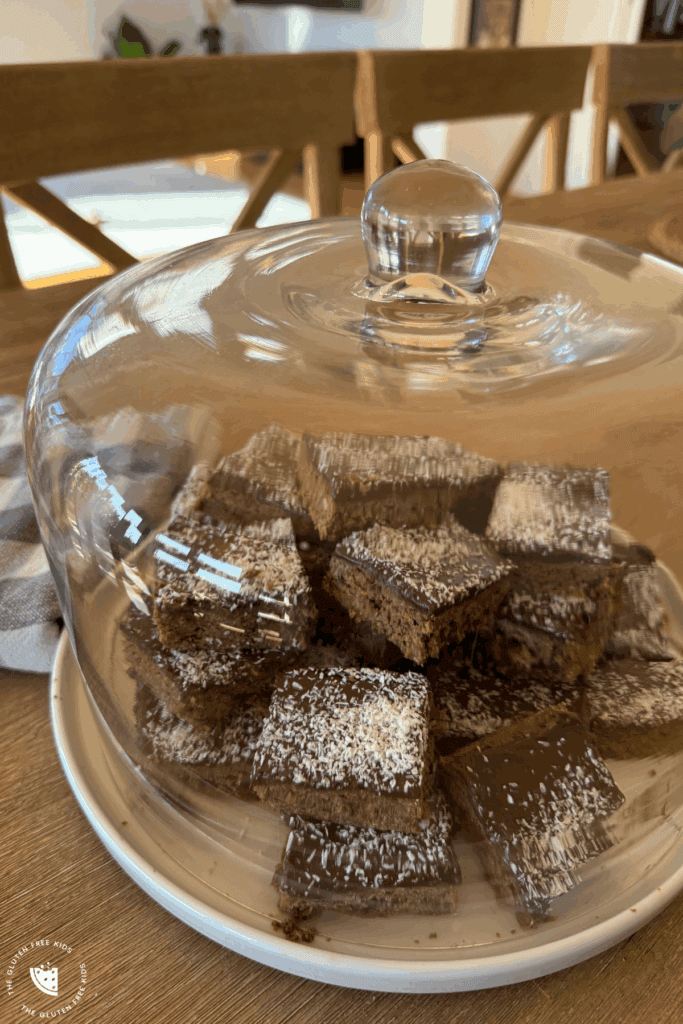 Squares of gluten-free chocolate cornflake bars with coconut on top