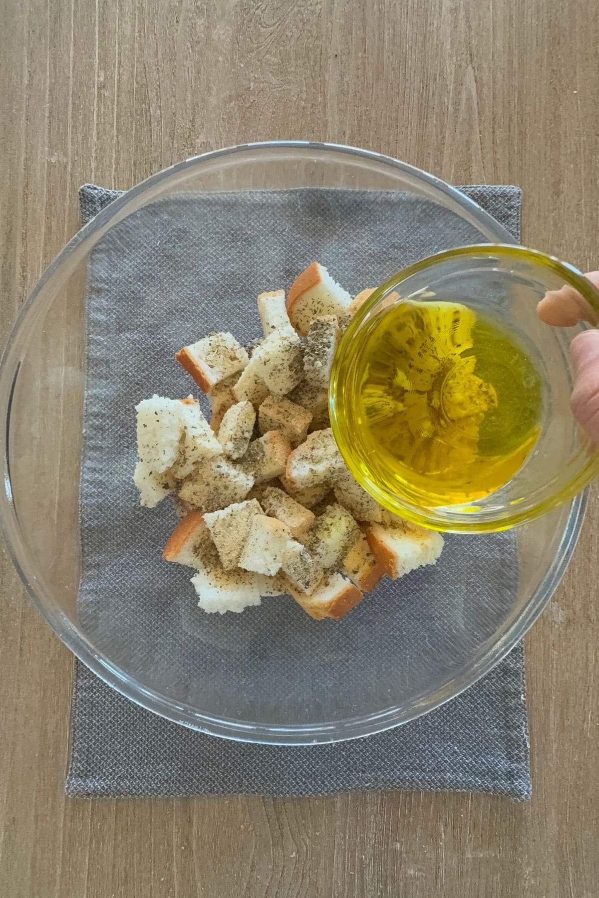 Bread cubes coated in olive oil and herbs, ready to bake