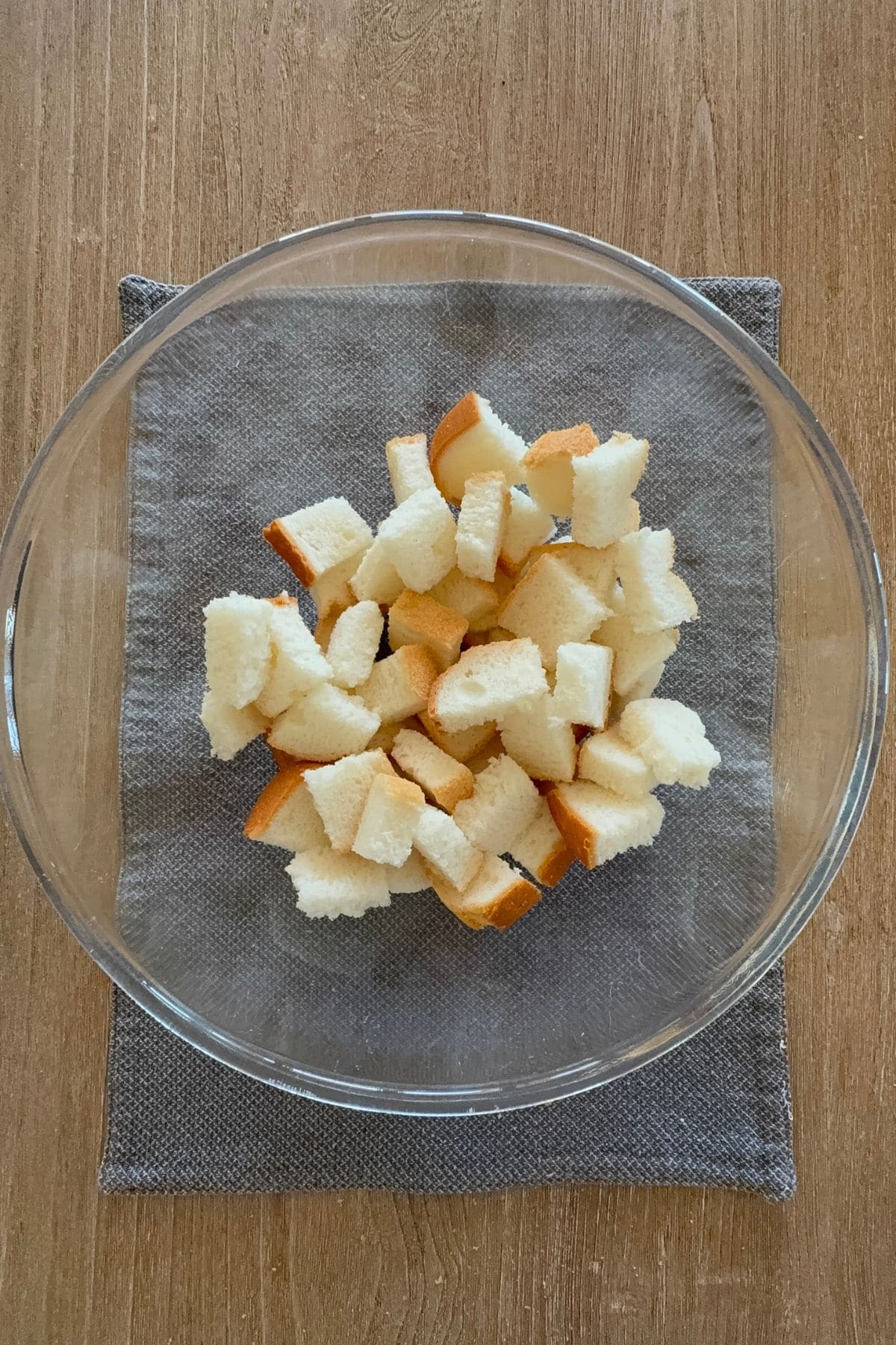 Cubed gluten-free bread in a mixing bowl before seasoning