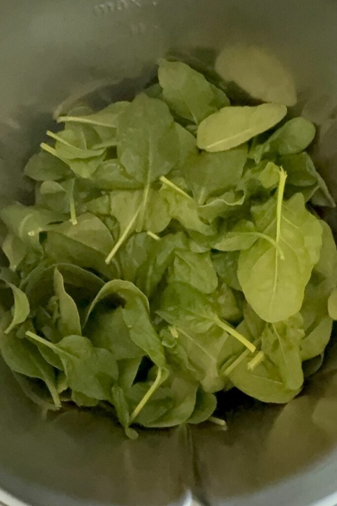 Fresh spinach, eggs, salt and pepper for gluten-free spinach wraps