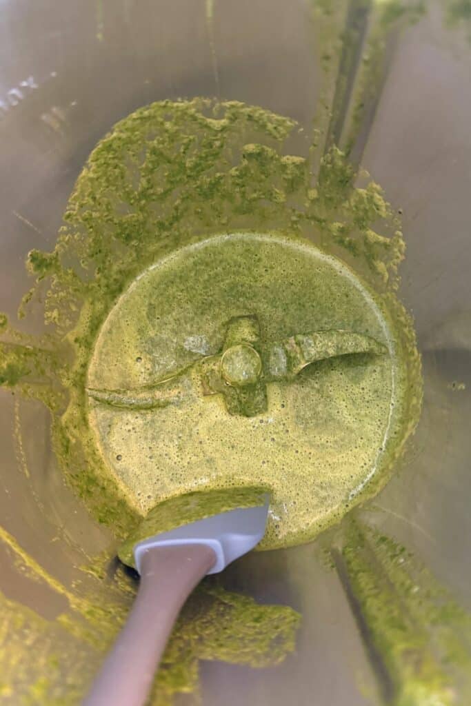 Smooth green spinach and egg batter in blender for gluten-free wraps