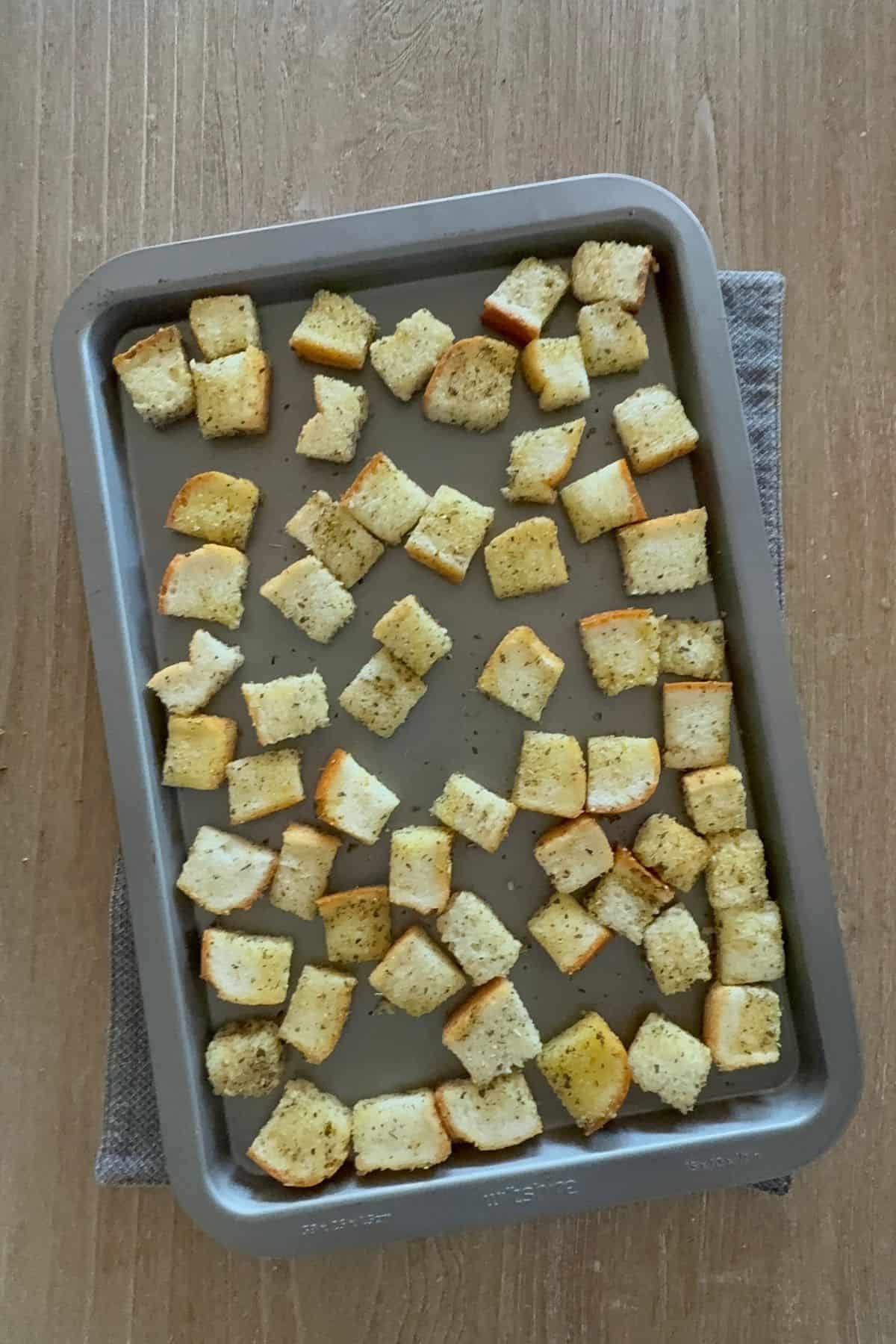 Spread gluten-free bread cubes on the tray in a single layer.