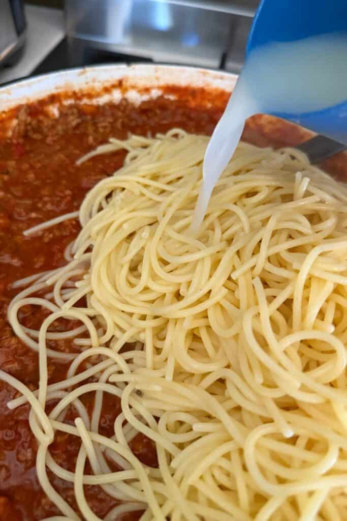 add pasta water to loosen and mix the pasta and sauce
