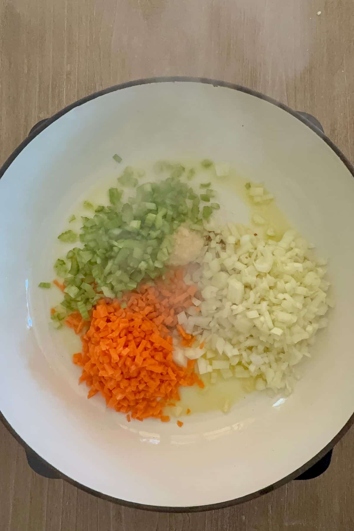 onion, garlic, carrot, and celery sauteing to make bolognese