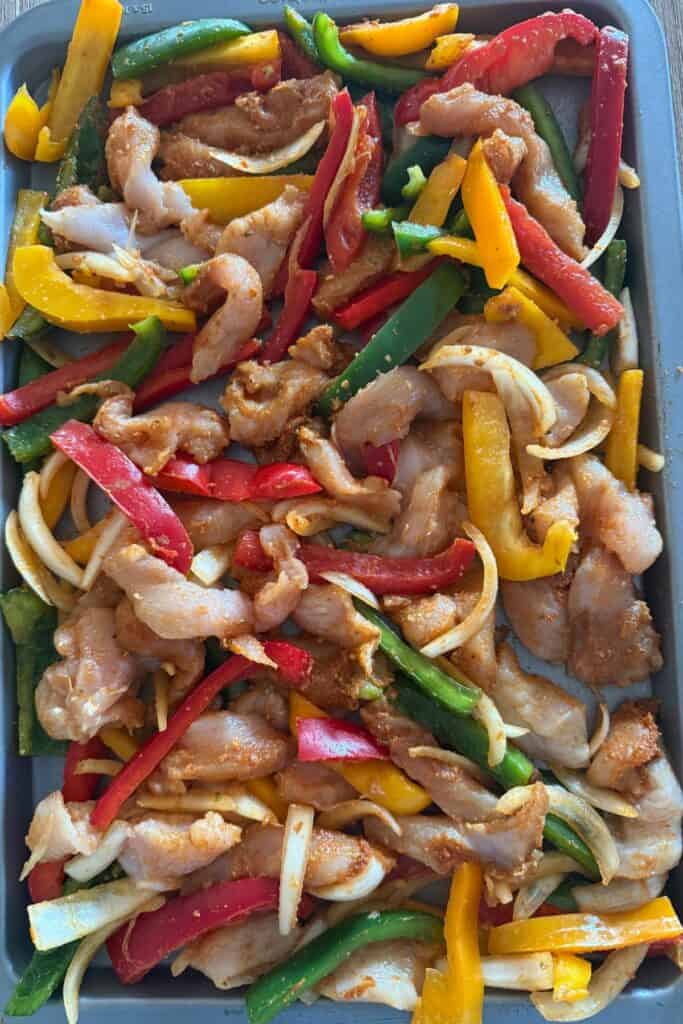 spread chicken fajita mix on a large baking tray