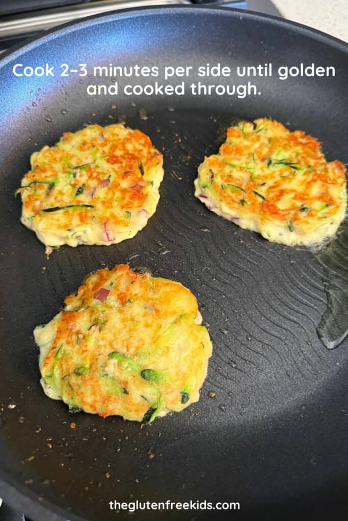 cooking zucchini fritters in medium heat pan