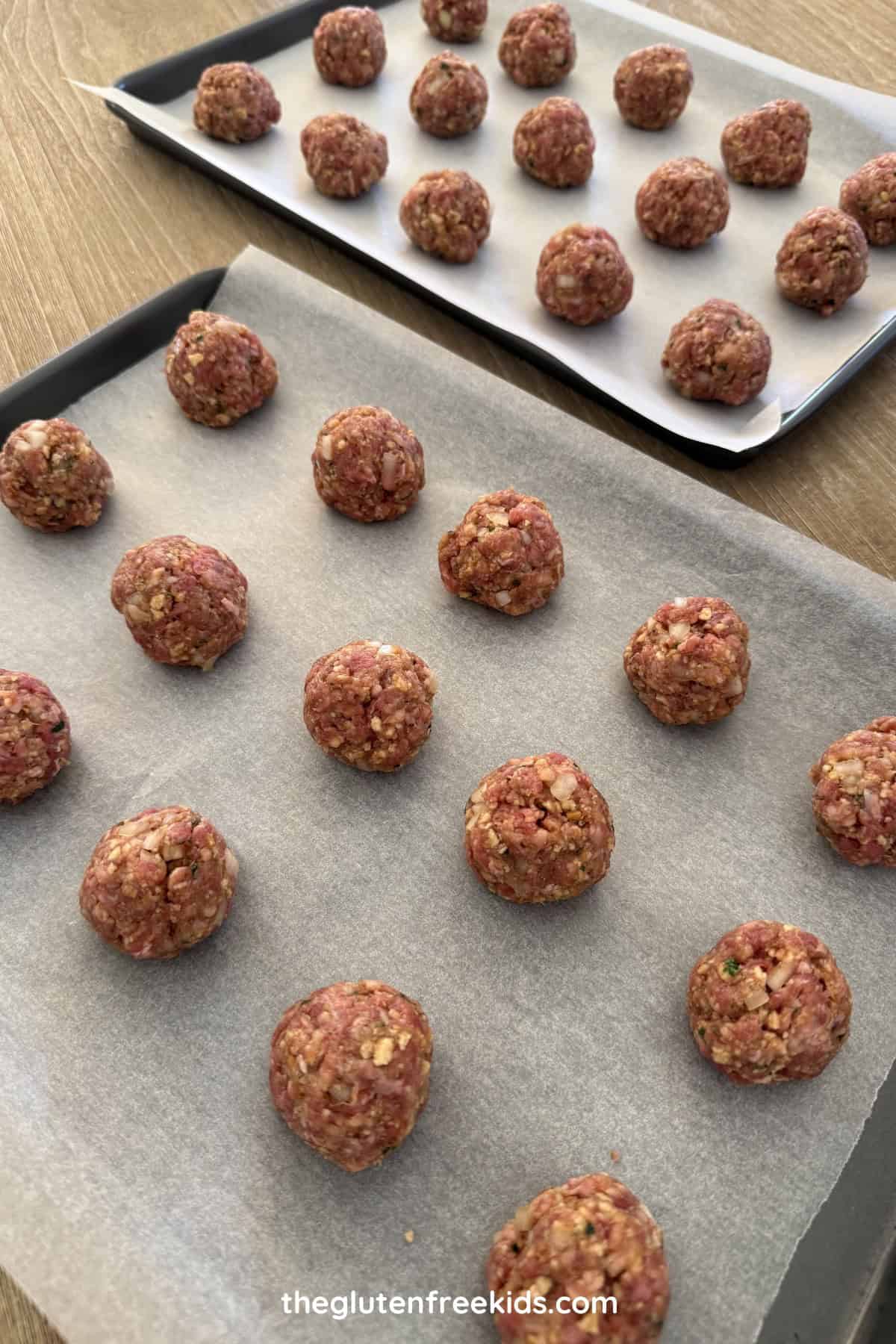 Tray of rolled Gluten-Free French Onion Meatballs ready to cook