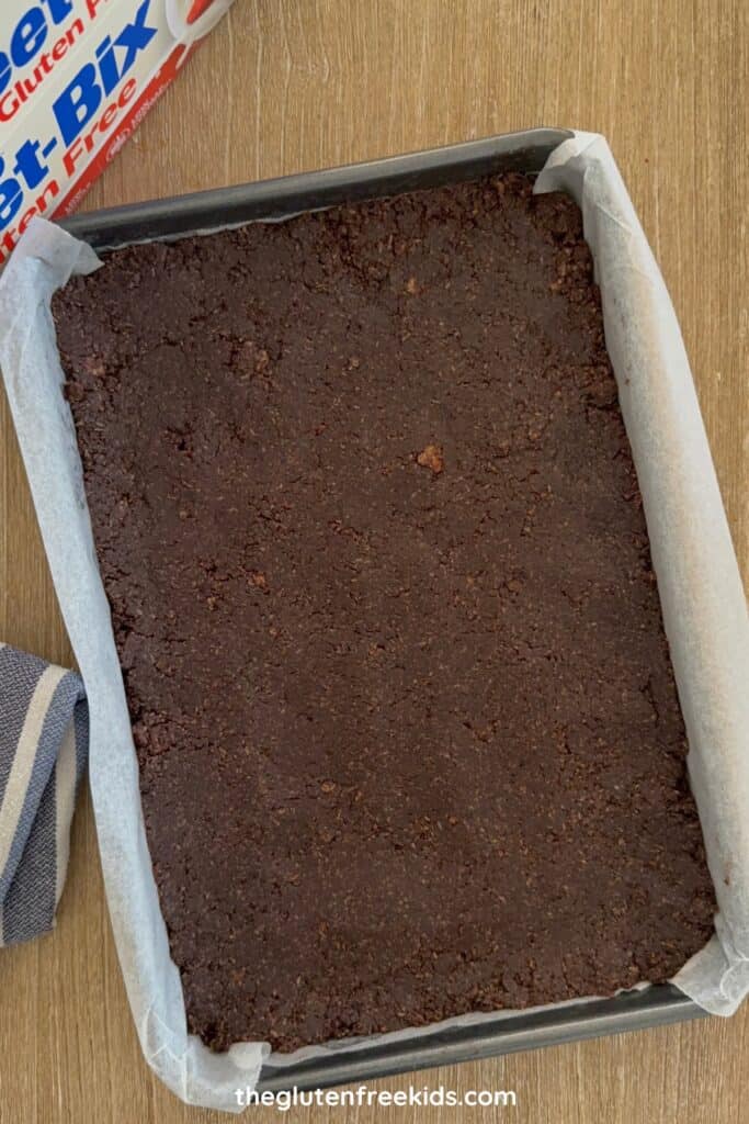 Press the mixture firmly into the prepared pan and smooth the top.